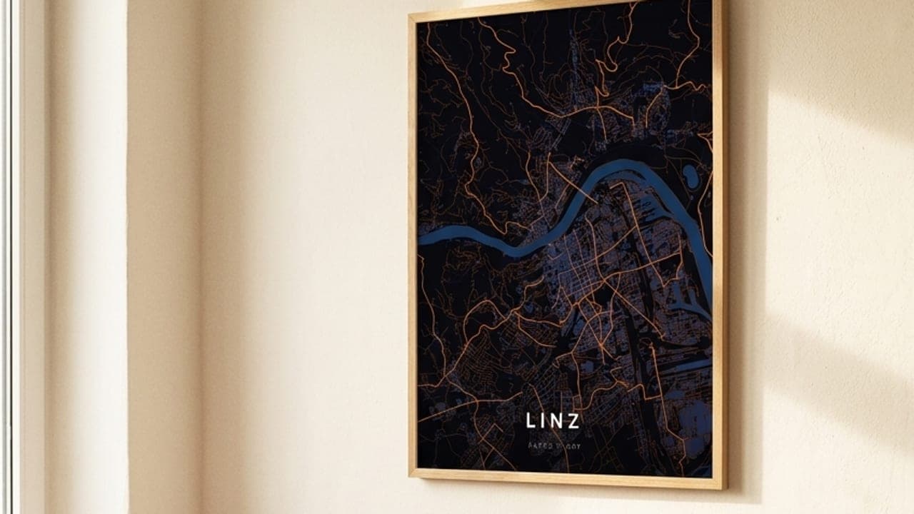 Framed Linz map poster above a pink sofa